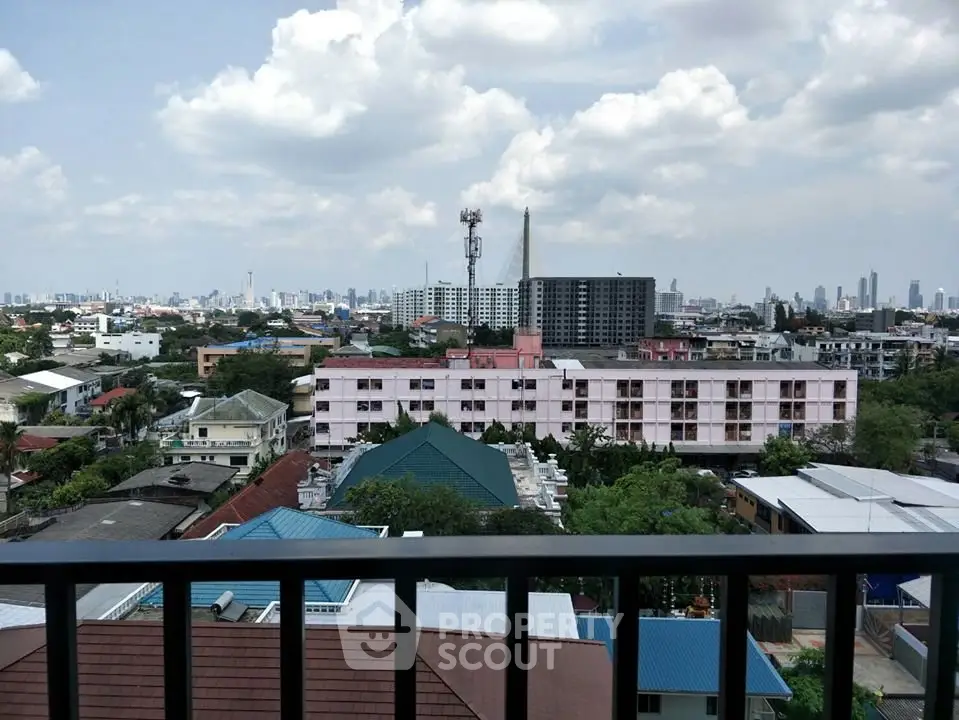 Stunning cityscape view from a high-rise balcony showcasing urban skyline and lush greenery.