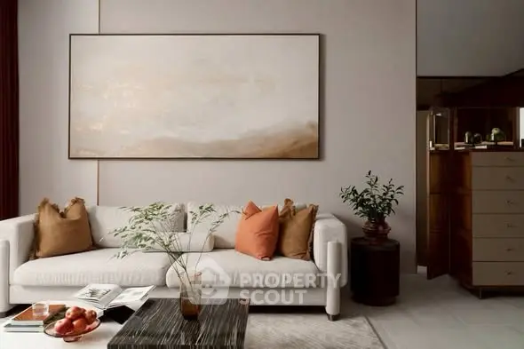 Elegant living room with modern sofa, stylish decor, and large wall art in a contemporary setting.