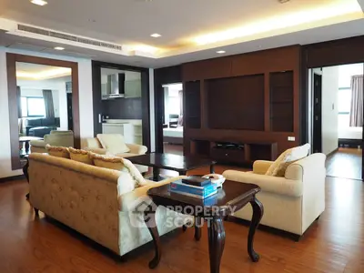 Spacious living room with elegant furniture and wooden flooring in a modern apartment.