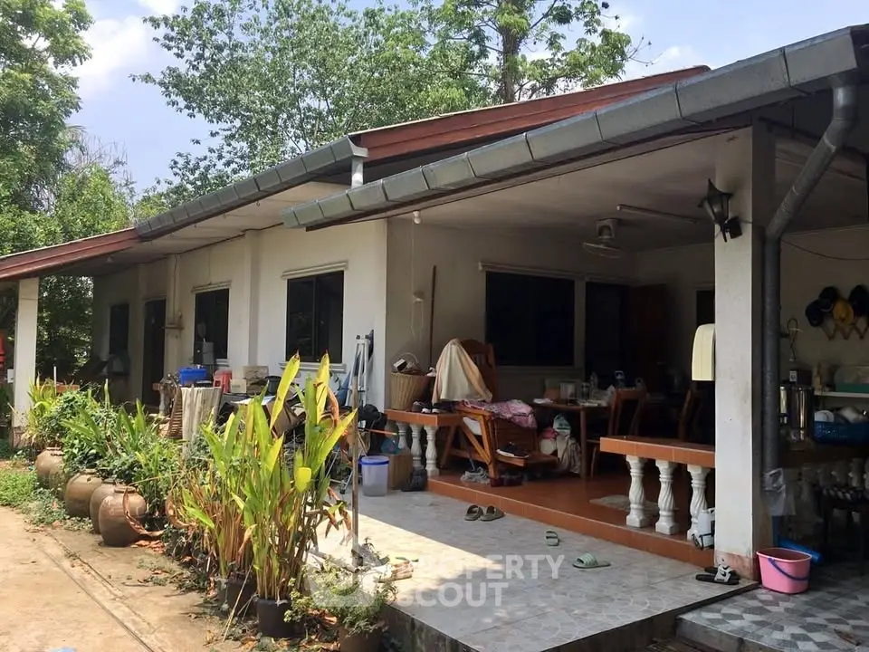 Charming single-story home with spacious porch and lush garden