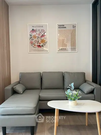 Modern living room with sleek gray sofa and stylish wall art