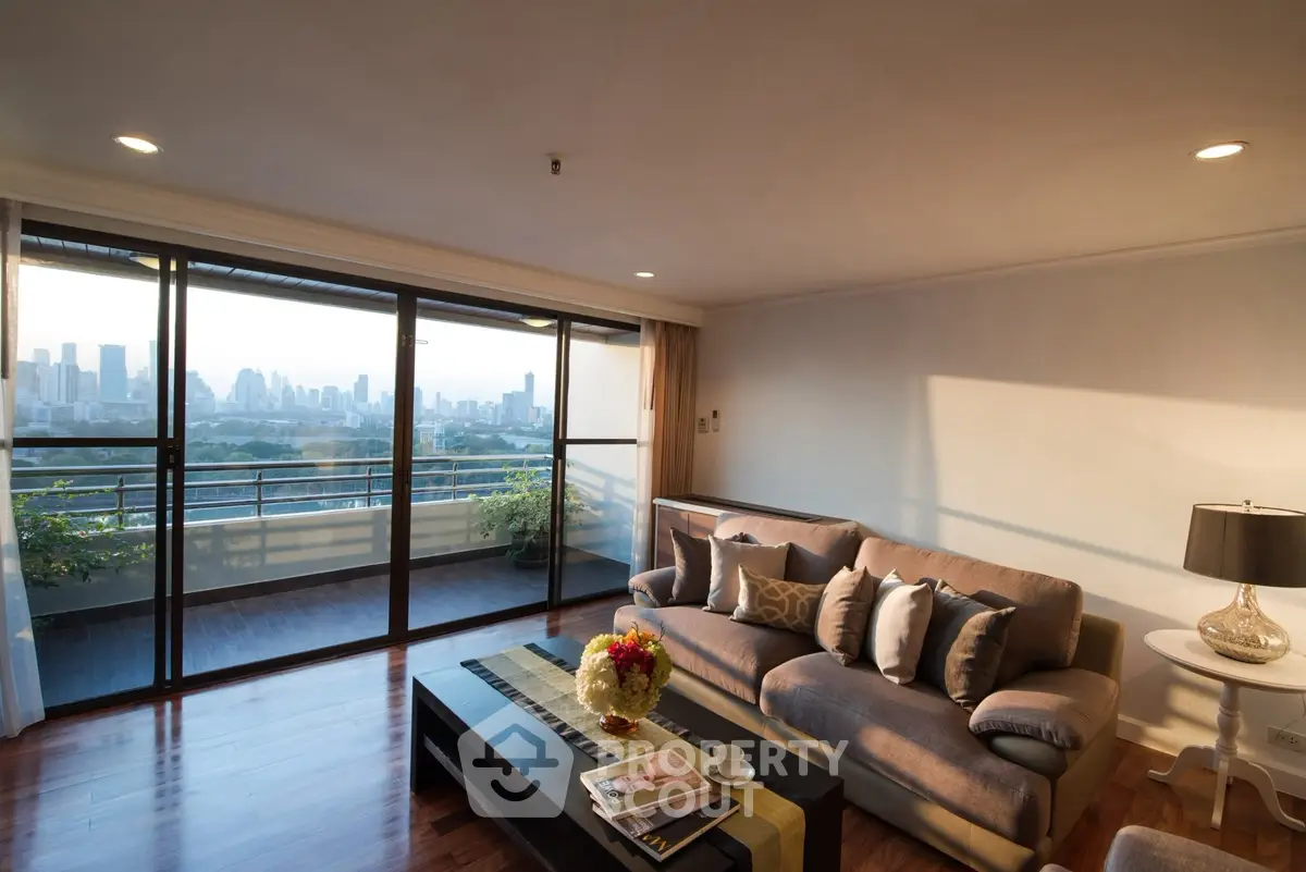 Spacious living room with stunning city view and large balcony access.