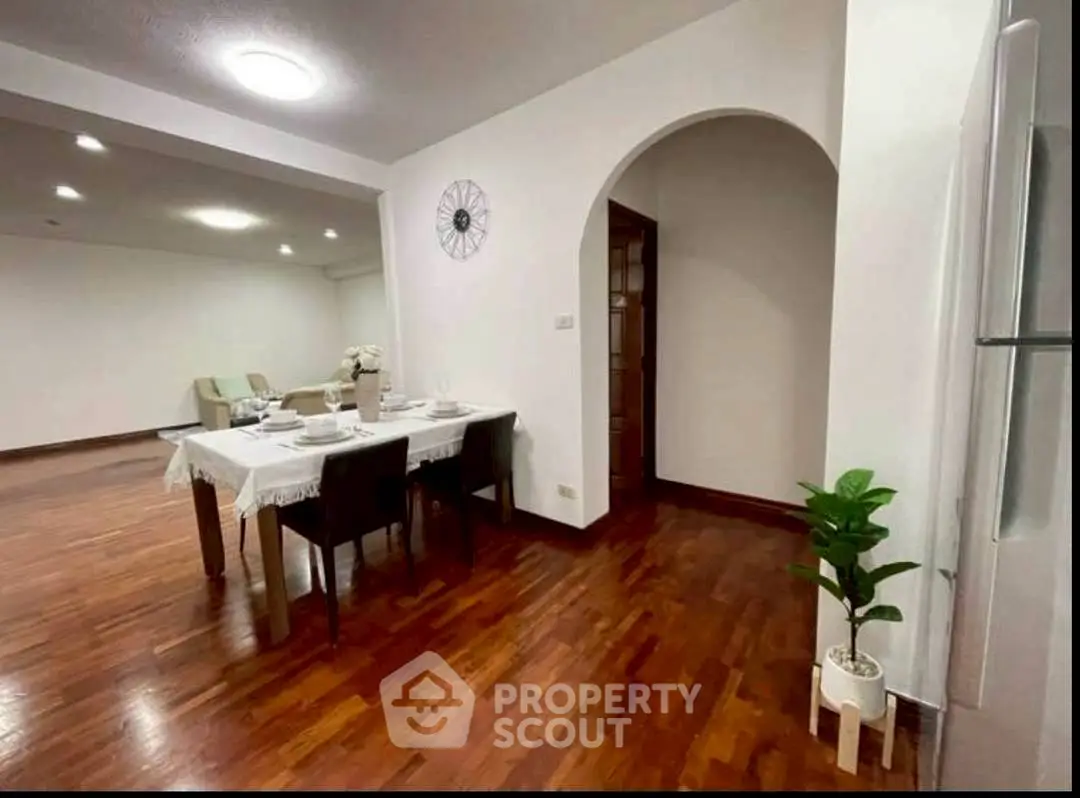 Spacious dining area with elegant wooden flooring and modern decor