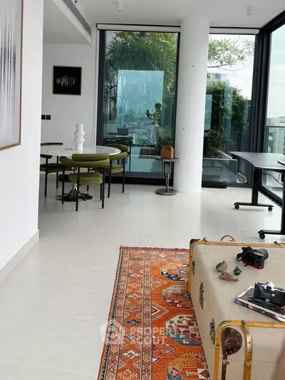Modern living room with stylish decor and large windows offering city views