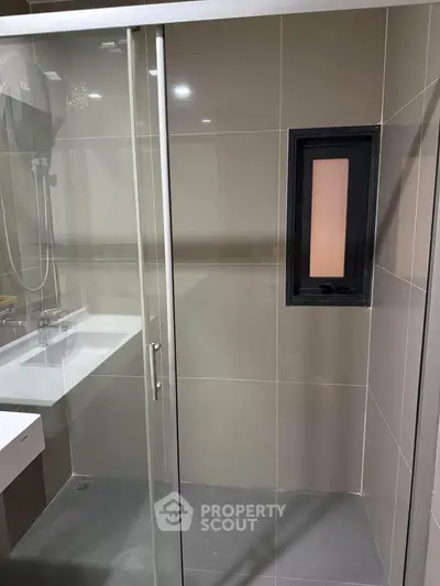 Modern bathroom with glass shower enclosure and sleek design