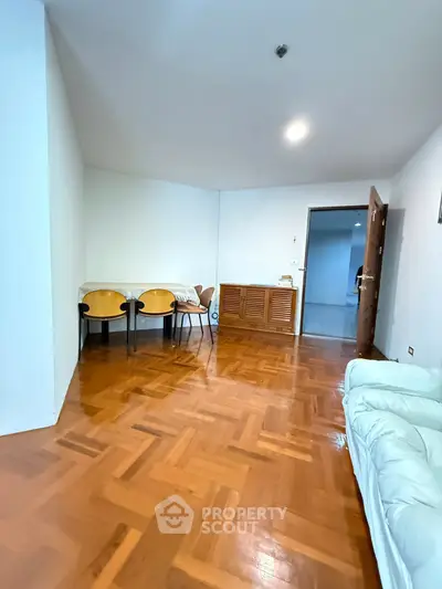 Spacious living room with wooden flooring and modern furniture