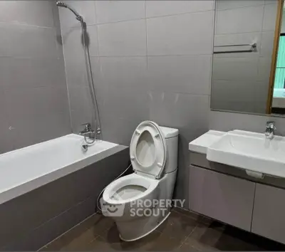 Modern bathroom with sleek fixtures and bathtub in contemporary apartment.