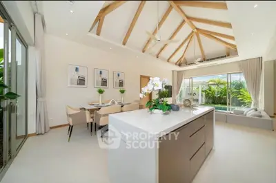 Luxurious open-plan living room with high ceilings and pool view