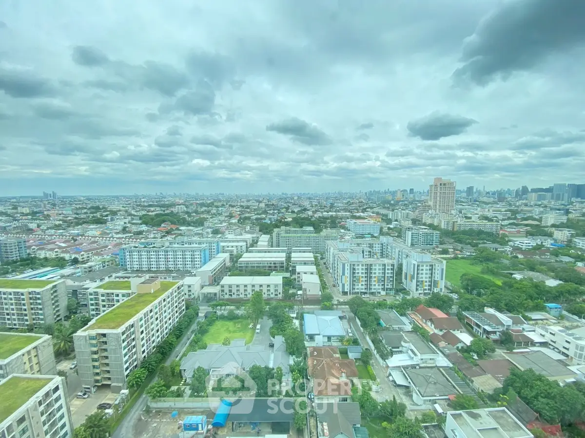 Stunning cityscape view from high-rise building showcasing urban landscape and greenery.