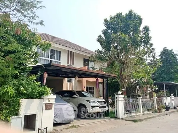 Charming suburban house with carport and lush greenery in a peaceful neighborhood.