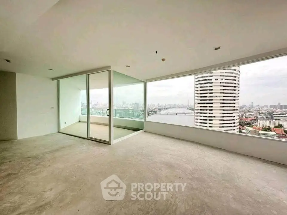 Spacious corner unit with panoramic city and river views, featuring floor-to-ceiling windows and a large balcony.