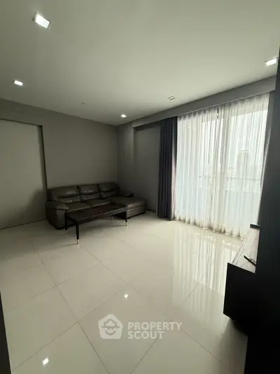 Spacious modern living room with sleek furniture and large windows