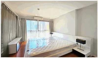 Spacious bedroom with large windows and modern decor, perfect for natural light lovers.