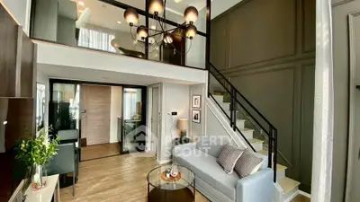 Modern loft-style living room with elegant chandelier and mezzanine