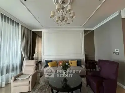 Elegant living room with plush seating and chandelier in modern apartment