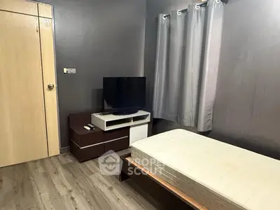 Cozy bedroom with modern decor and sleek furnishings, perfect for urban living.