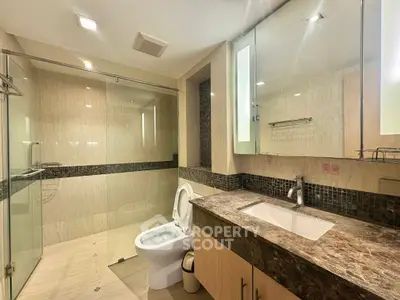 Luxurious modern bathroom with marble countertop and glass shower enclosure