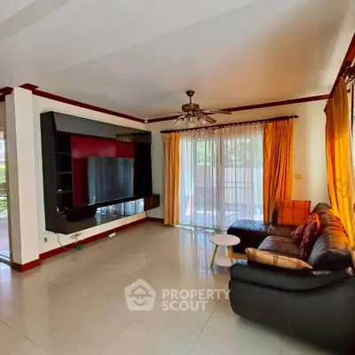 Spacious living room with modern decor and large windows for natural light.