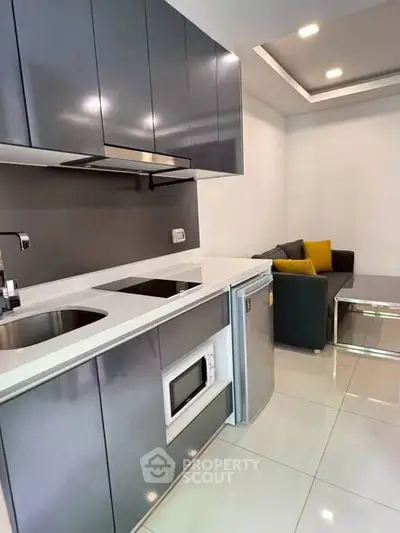 Modern compact kitchen with sleek cabinets and integrated appliances