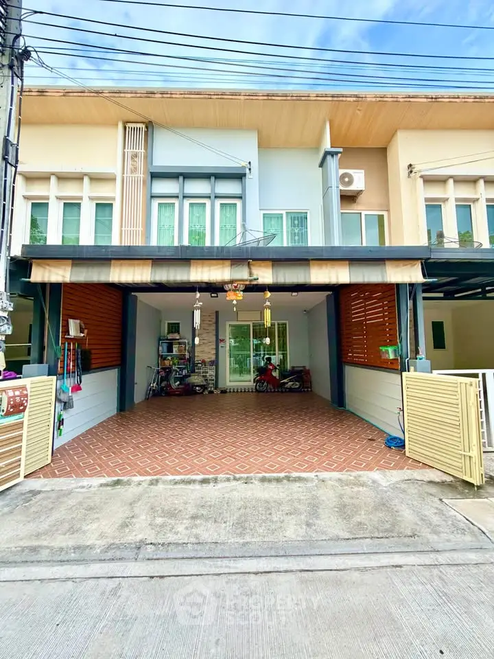 Charming townhouse with spacious garage and modern facade in a serene neighborhood.