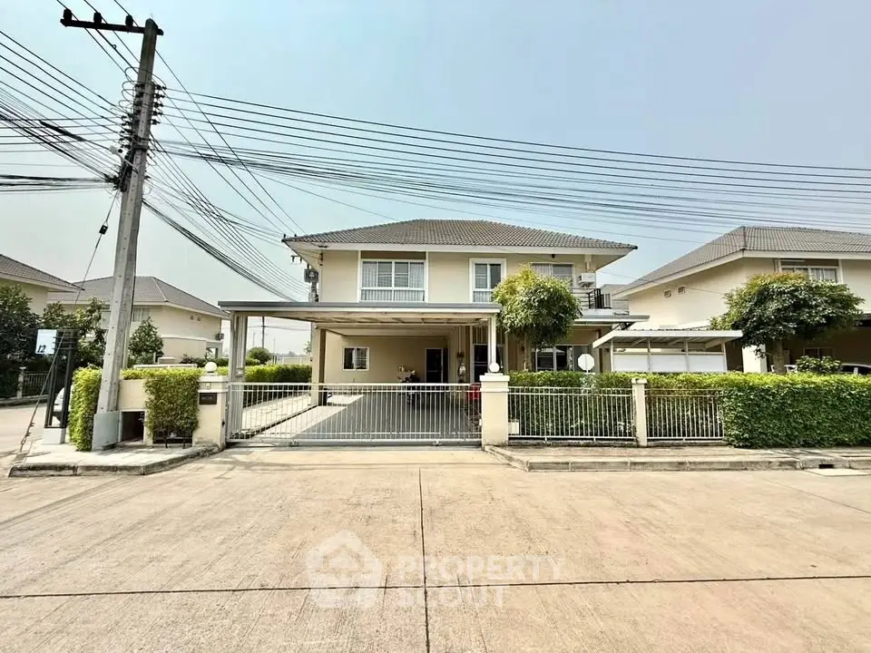 Spacious two-story house with driveway and lush greenery in a serene neighborhood.