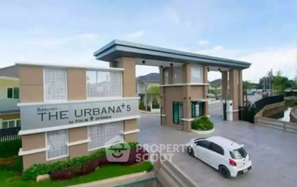 Modern gated community entrance with sleek design and security features.