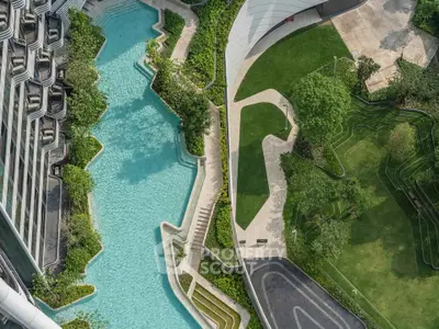 Stunning aerial view of modern building with luxurious pool and landscaped gardens, perfect for urban living.