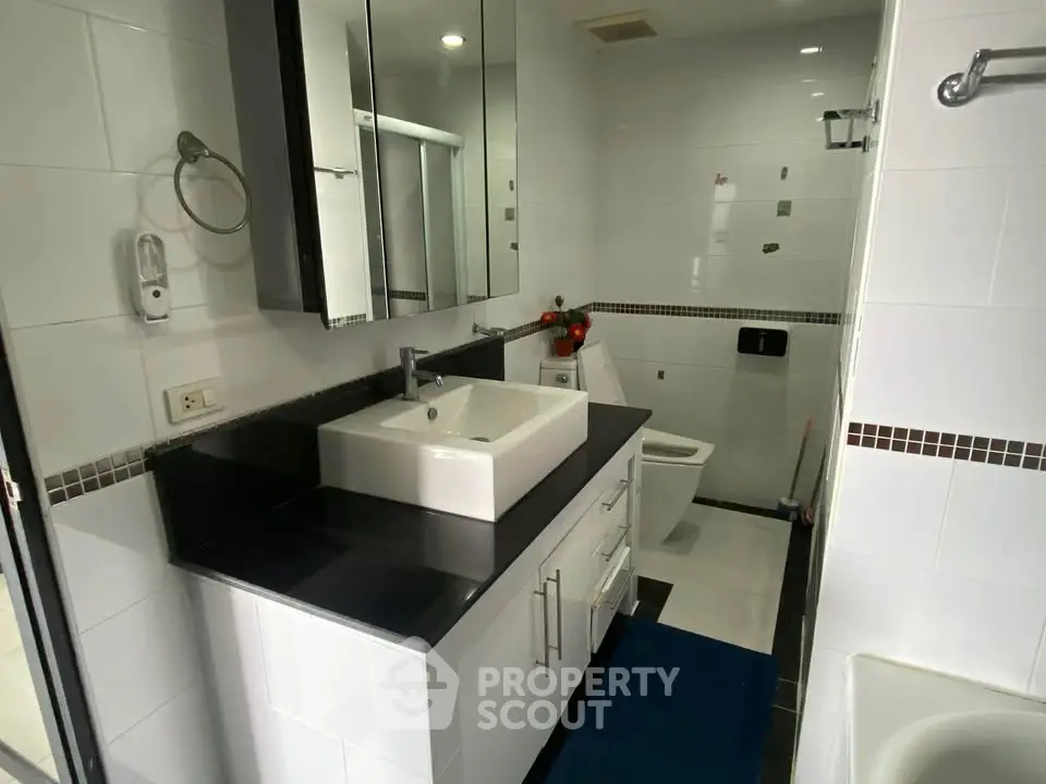 Modern bathroom with sleek fixtures and elegant black countertop