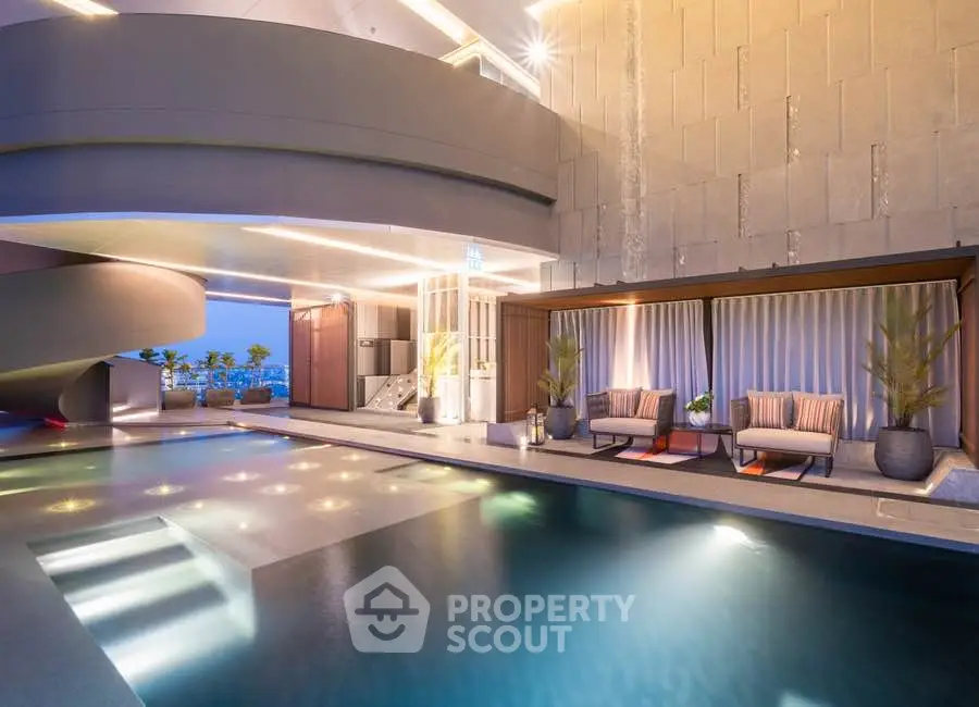 Luxurious rooftop pool with elegant seating and stunning city views, perfect for relaxation and entertainment.