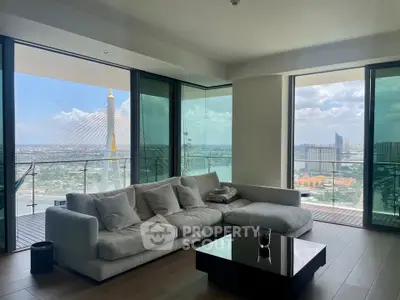 Luxurious living room with stunning city view and spacious balcony in modern high-rise apartment.