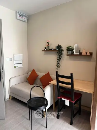 Cozy living room with modern decor and stylish furniture, perfect for relaxation and work-from-home setup.