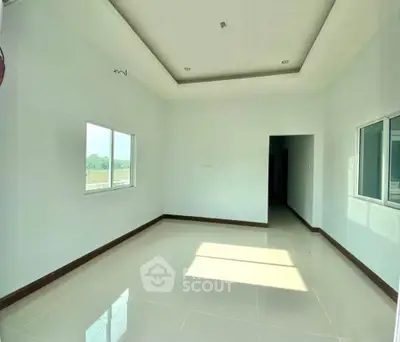Spacious empty room with large windows and glossy tiled floor, perfect for customization.