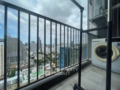High-rise balcony with cityscape view and washing machine, perfect urban living.