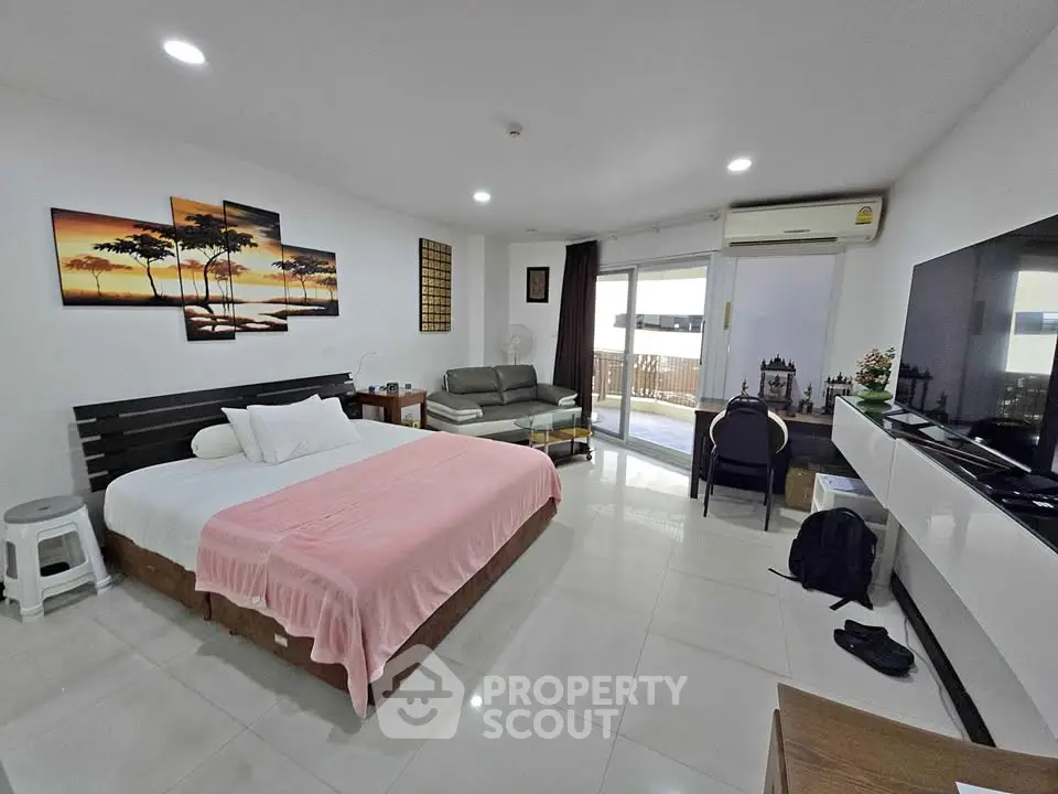 Spacious modern bedroom with balcony and stylish decor