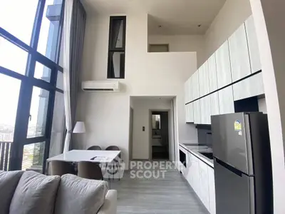 Modern high-rise apartment with open kitchen and stunning city view.