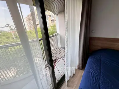 Cozy bedroom with balcony access and scenic view, perfect for relaxation and enjoying fresh air.