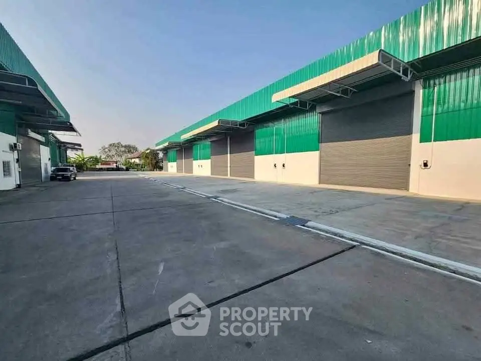 Spacious industrial warehouse with large loading bays and ample parking space.