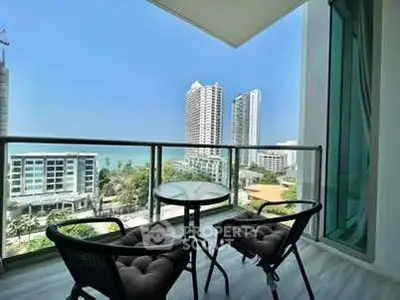 Stunning balcony view with modern furniture overlooking city skyline and ocean.