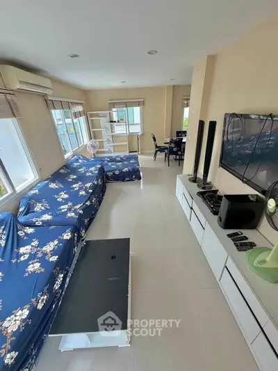 Spacious living room with modern decor and large windows for natural light.