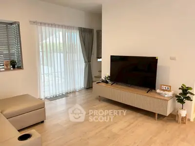 Modern living room with sleek TV stand and natural light
