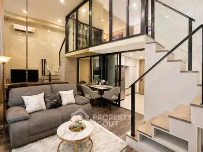 Luxurious modern living room with mezzanine, elegant decor, and open dining area in a stylish apartment.