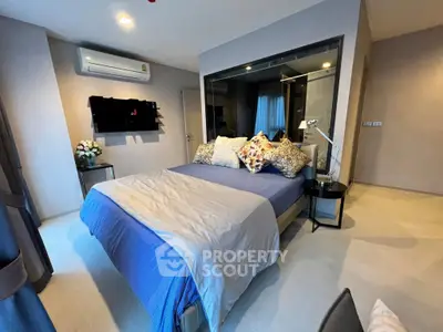 Modern bedroom with stylish decor and air conditioning in a contemporary apartment.