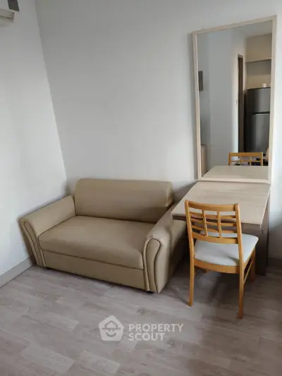 Cozy living room with beige sofa and wooden furniture, perfect for modern apartments.