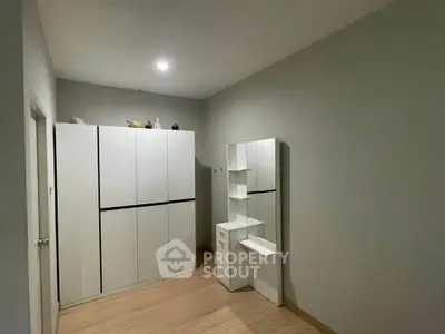 Spacious storage room with modern white cabinets and sleek design
