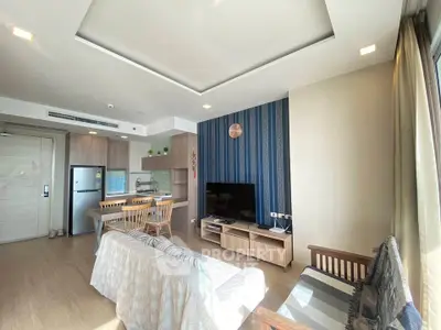 Modern living room with open kitchen, stylish decor, and ample natural light in a contemporary apartment.
