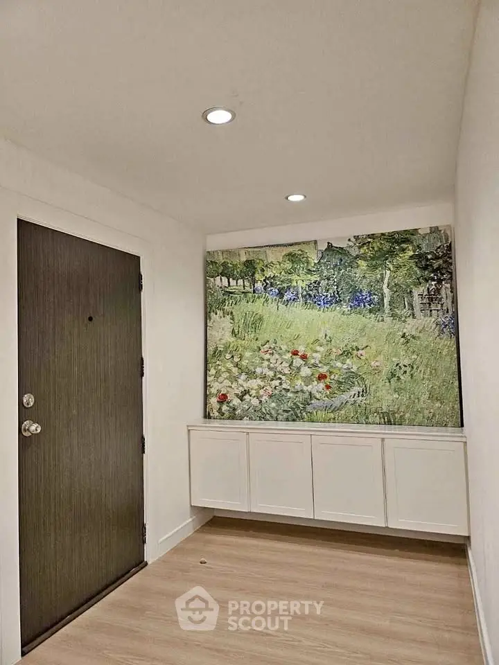 Stylish entryway with elegant artwork and modern lighting