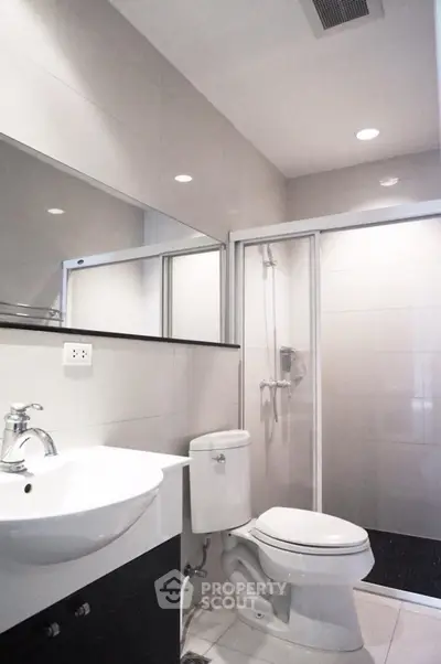Modern bathroom with sleek fixtures and glass shower enclosure