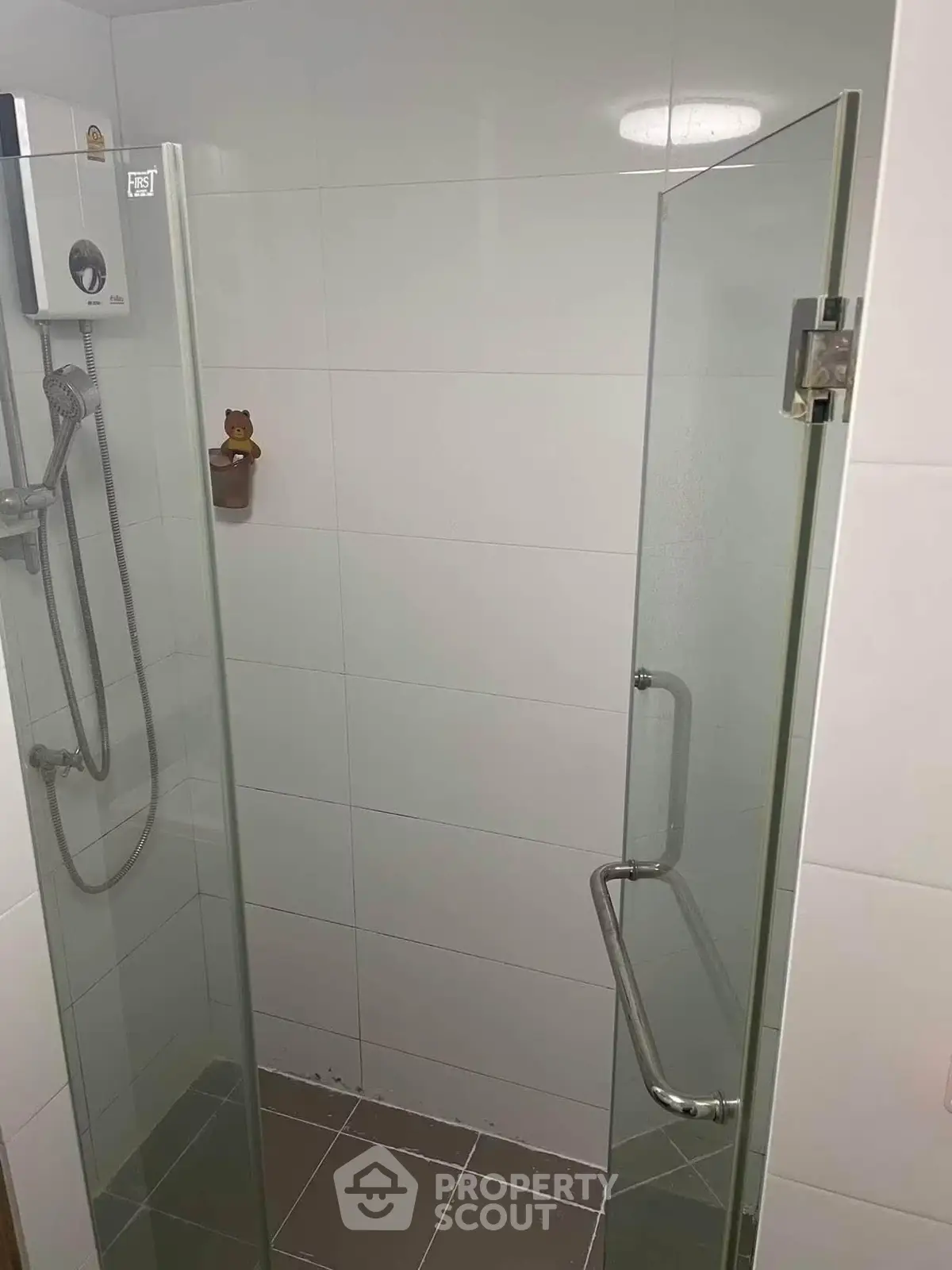 Modern bathroom with glass shower enclosure and sleek fixtures.