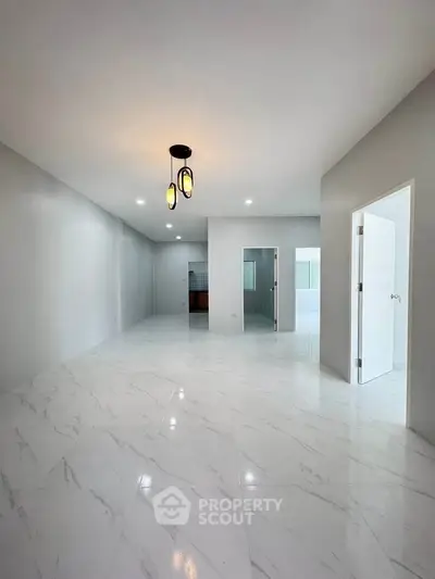 Spacious modern interior with marble flooring and elegant lighting, perfect for stylish living.