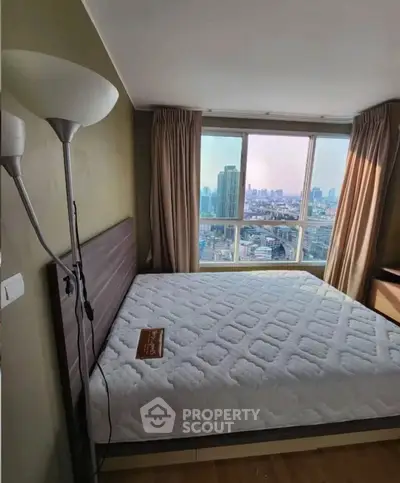 Spacious bedroom with city view in modern high-rise apartment